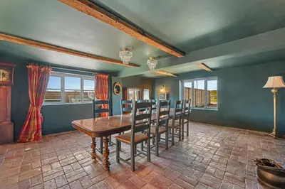 a dining room with a wooden table and chairs at Bakers Cottage, Blackmore End in Gosfield