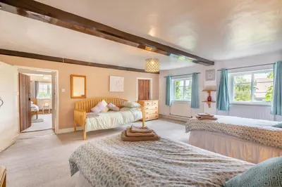 a bedroom with two beds and a couch at 4 Bed in East Harling oc-m31907 in East Harling