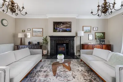 a living room with two couches and a fireplace at Merry Lakes - Luxury Lakeside Escape with Pool - Just 30 Minutes from London in Hutton