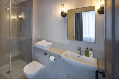 a bathroom with a sink and a toilet and a shower at The Ship Hotel in Southend-on-Sea