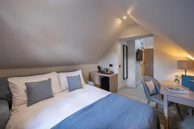 a hotel room with a bed and a desk and a desk at The Ship Hotel in Southend-on-Sea