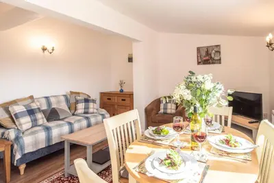 a living room with a table and a couch at The Old Dairy, Cookley in Cookley