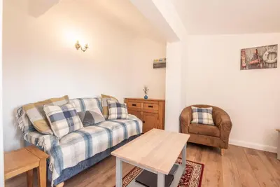 a living room with a couch and a chair at The Old Dairy, Cookley in Cookley