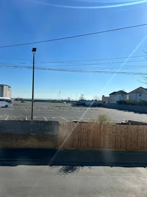 a parking lot with a fence and a street light at Dolce Vita on Sea in Southend-on-Sea