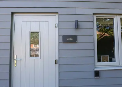 a door of a house with a sign on it at Gala Suite - The Apple Barn in Pettistree