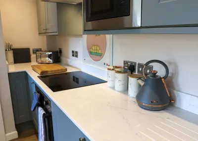 a kitchen counter with a tea kettle on it at Gala Suite - The Apple Barn in Pettistree