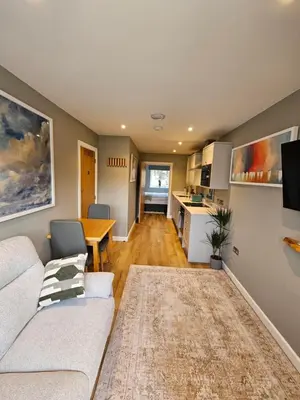 a living room with a couch and a table at Russet Suite - The Apple Barn in Pettistree