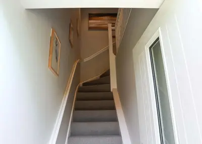 a staircase in a home with a stair case at Discovery Suite - The Apple Barn in Pettistree
