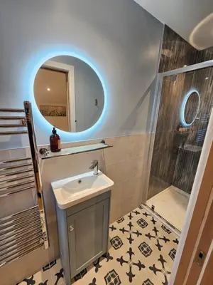 a bathroom with a sink and a mirror and a shower at Cameo Suite - The Apple Barn in Pettistree