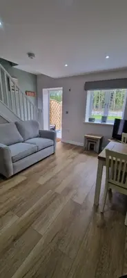 a living room with a couch and a table at Cameo Suite - The Apple Barn in Pettistree