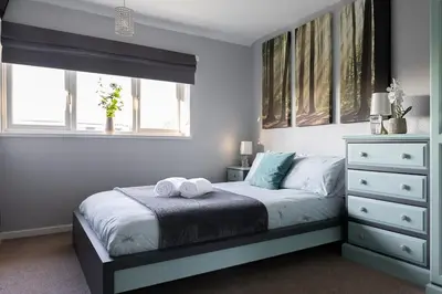 a bedroom with a bed with two towels on it at Clicketts - 3-Bedroom, Full Entire House, Sleeps 6 guests, Free wifi, Street Parking, Smart TV, Basildon, Essex London in Basildon