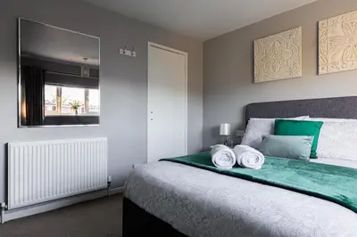 a bedroom with a bed with two towels on it at Clicketts - 3-Bedroom, Full Entire House, Sleeps 6 guests, Free wifi, Street Parking, Smart TV, Basildon, Essex London in Basildon