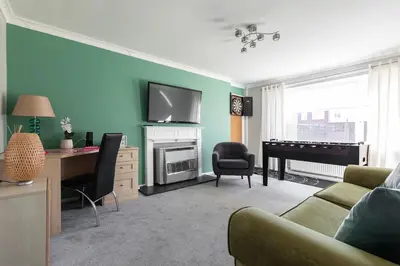a living room with a couch and a piano at Clicketts - 3-Bedroom, Full Entire House, Sleeps 6 guests, Free wifi, Street Parking, Smart TV, Basildon, Essex London in Basildon