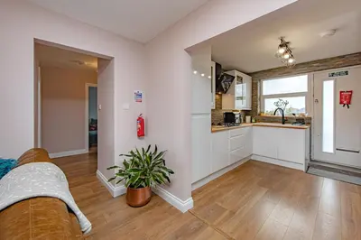 a living room with a couch and a kitchen at Coastal Charm In Clacton On Sea in Holland-on-Sea