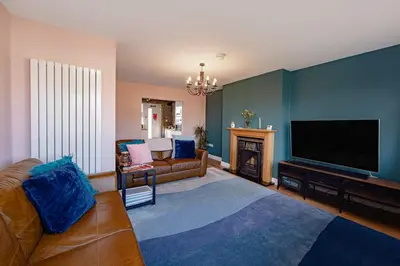 a living room with a flat screen tv and a couch at Coastal Charm In Clacton On Sea in Holland-on-Sea