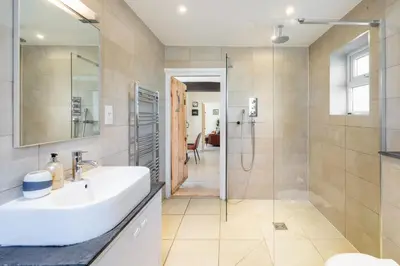 a bathroom with a sink and a shower at 5 Mill Cottage in Yoxford