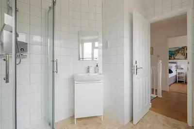 a bathroom with a sink and a glass shower at Luxury City House - 1 min from river - Parking - Sleeps 10 in Cambridge