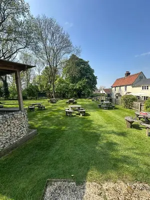 a park with picnic tables in the grass at Black Horse in Brent Pelham