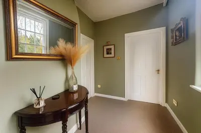 a hallway with a table and a window and a mirror at Black Horse in Brent Pelham