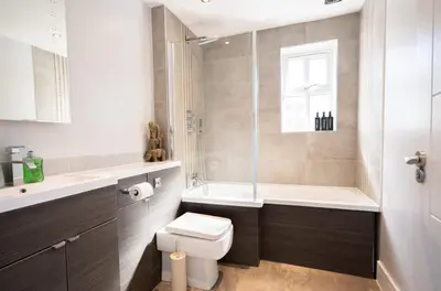 a bathroom with a toilet and a tub and a sink at Vineyard Style 2BR with Garden and Parking in Shudy Camps