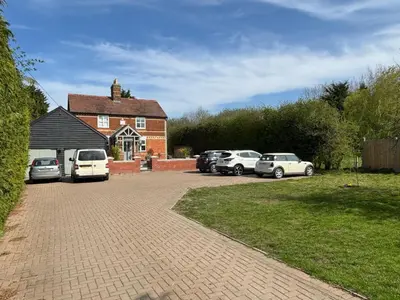 a group of cars parked in front of a house at Vineyard Style 2BR with Garden and Parking in Shudy Camps