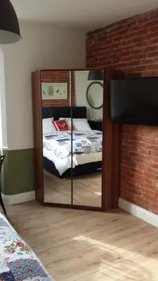 a mirror in a bedroom with a bed at The Railway Inn Westerfield in Ipswich