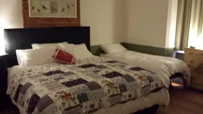 a bedroom with a bed with a quilt on it at The Railway Inn Westerfield in Ipswich