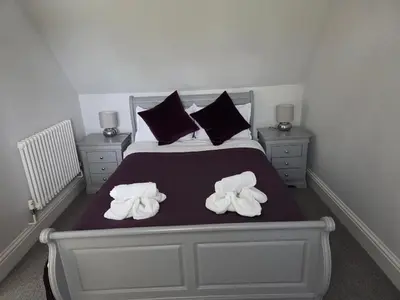 a bedroom with a bed with towels on it at Little George in Rayne
