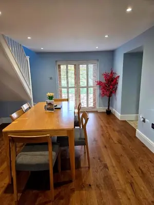 a dining room with a wooden table and blue walls at Little George in Rayne