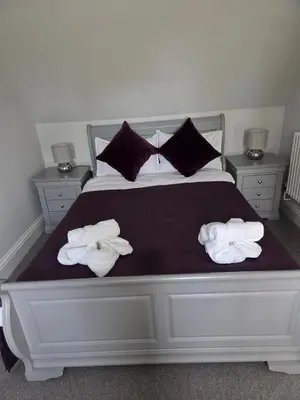 a bedroom with a bed with towels on it at Little George in Rayne