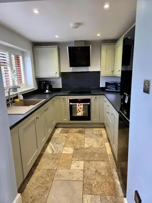 a kitchen with white cabinets and a stove top oven at Little George in Rayne
