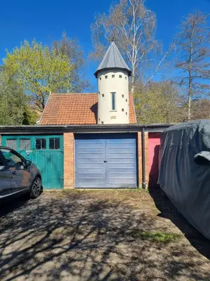 a garage with a tower on top of a house at Blossom House in Woodbridge