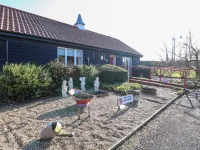 a yard with figurines in front of a house at Swallow Barn in Halesworth
