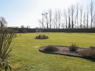 a picnic table in the middle of a park at Swallow Barn in Halesworth