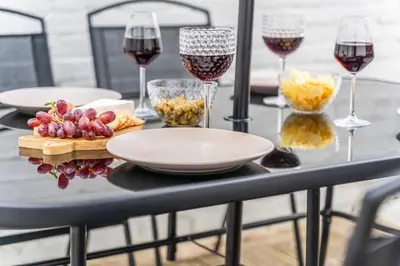 a table topped with glasses of wine and snacks at Cozy accessible 2bd flat on Mill road with firepit for a lovely winters night in Cambridge