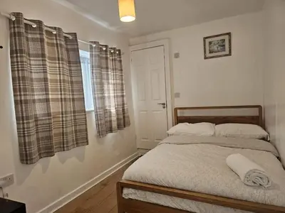 a bedroom with a bed and a window at Seafront 2-Bed Apt Sleeps 4 in Clacton-on-Sea in Clacton-on-Sea