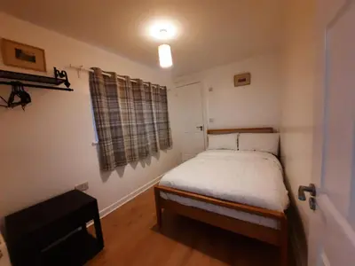 a small bedroom with a bed and a window at Seafront 2-Bed Apt Sleeps 4 in Clacton-on-Sea in Clacton-on-Sea