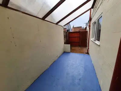 a hallway with a blue floor in a building at Seafront 2-Bed Apt Sleeps 4 in Clacton-on-Sea in Clacton-on-Sea