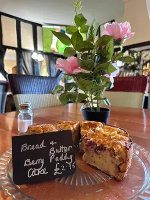 a plate with a piece of cake on a table at Forrester Park Glamping Pods - Eagle Pod and Birdie Pods in Great Totham