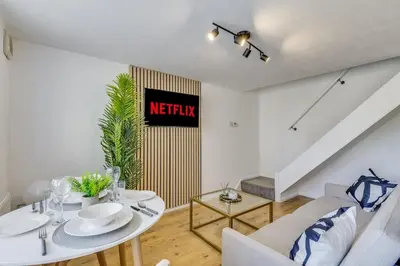 a living room with a white table and chairs at Cozy Riverside Cottage in Hertford Town with Parking in Hertford