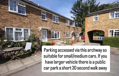 a brick house with a sign in front of it at Cozy Riverside Cottage in Hertford Town with Parking in Hertford