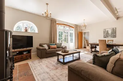a living room with a couch and a tv at Charming Rural Coach House Retreat - Wymondham in Wymondham