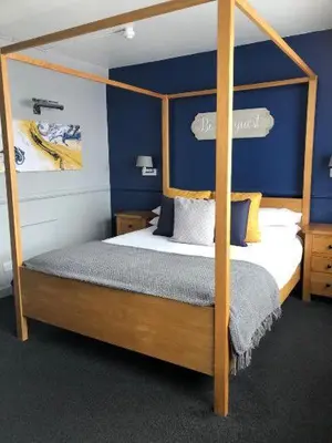 a bedroom with a four post canopy bed at The White Hart Hotel Witham in Witham