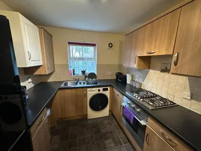 a kitchen with a sink and a stove top oven at Cosy En-suite Rooms - Ipswich in Ipswich
