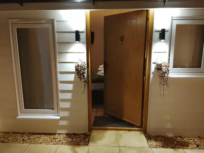 a door leading into a room with a mirror at The Beehive Inn in Bury Saint Edmunds
