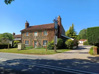 a brick house on the side of a street at The Beehive Inn in Bury Saint Edmunds