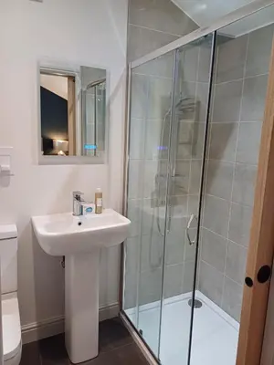 a bathroom with a sink and a shower at The Beehive Inn in Bury Saint Edmunds