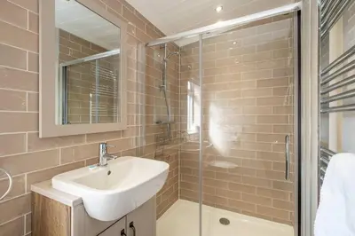 a bathroom with a sink and a shower at Driftwood Lodge, Sizewell - Adults only property - Aldeburgh Coastal Cottages in Sizewell