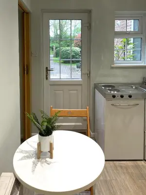 a kitchen with a table with a plant on it at Cosy Home Opposite Addenbrookes Hospital - Free Parking in Cambridge