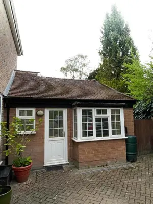 a small red brick house with a white door at Cosy Home Opposite Addenbrookes Hospital - Free Parking in Cambridge